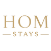 Gold 'HOM STAYS' text on a white background